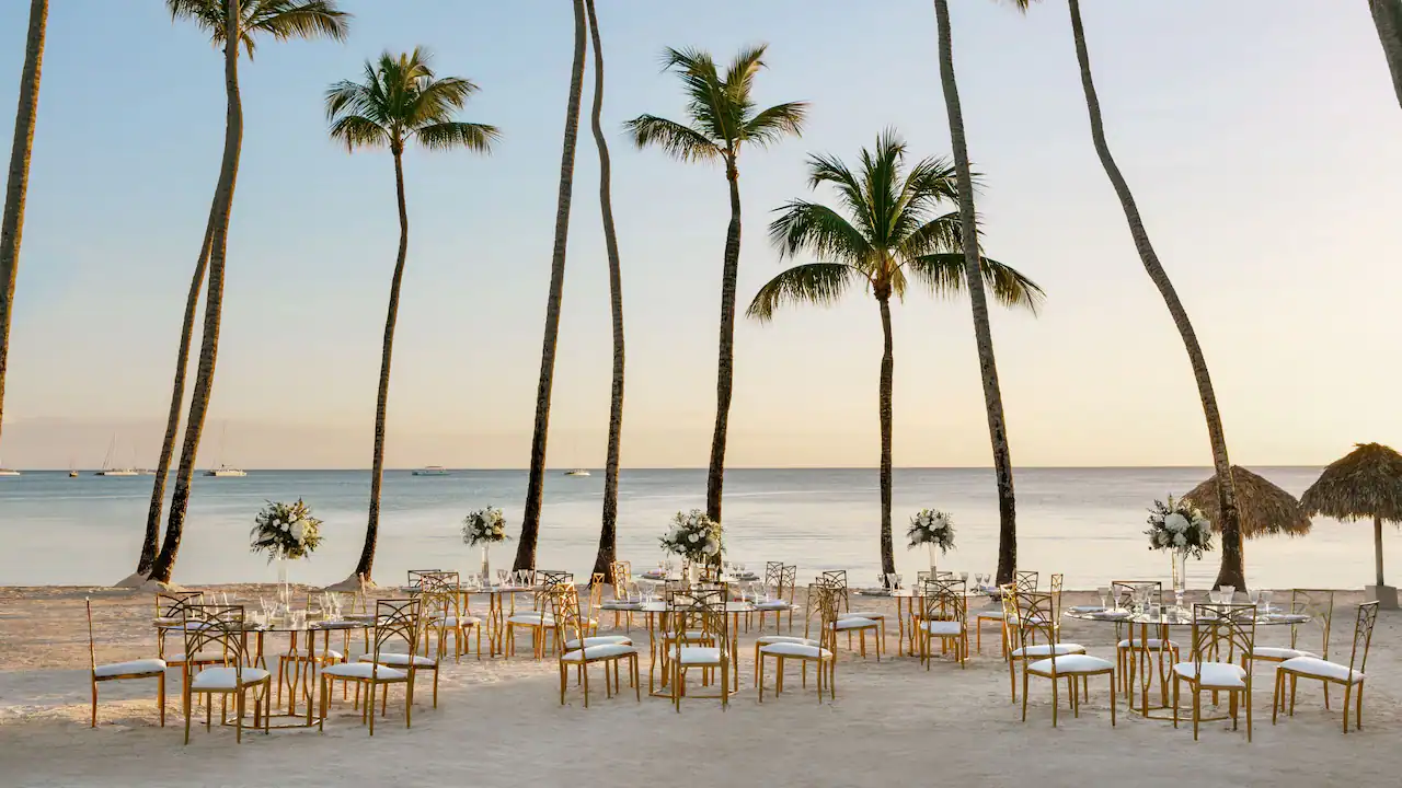 Elegant wedding ceremony seating arranged on the beach at Secrets La Romana Resort & Spa.