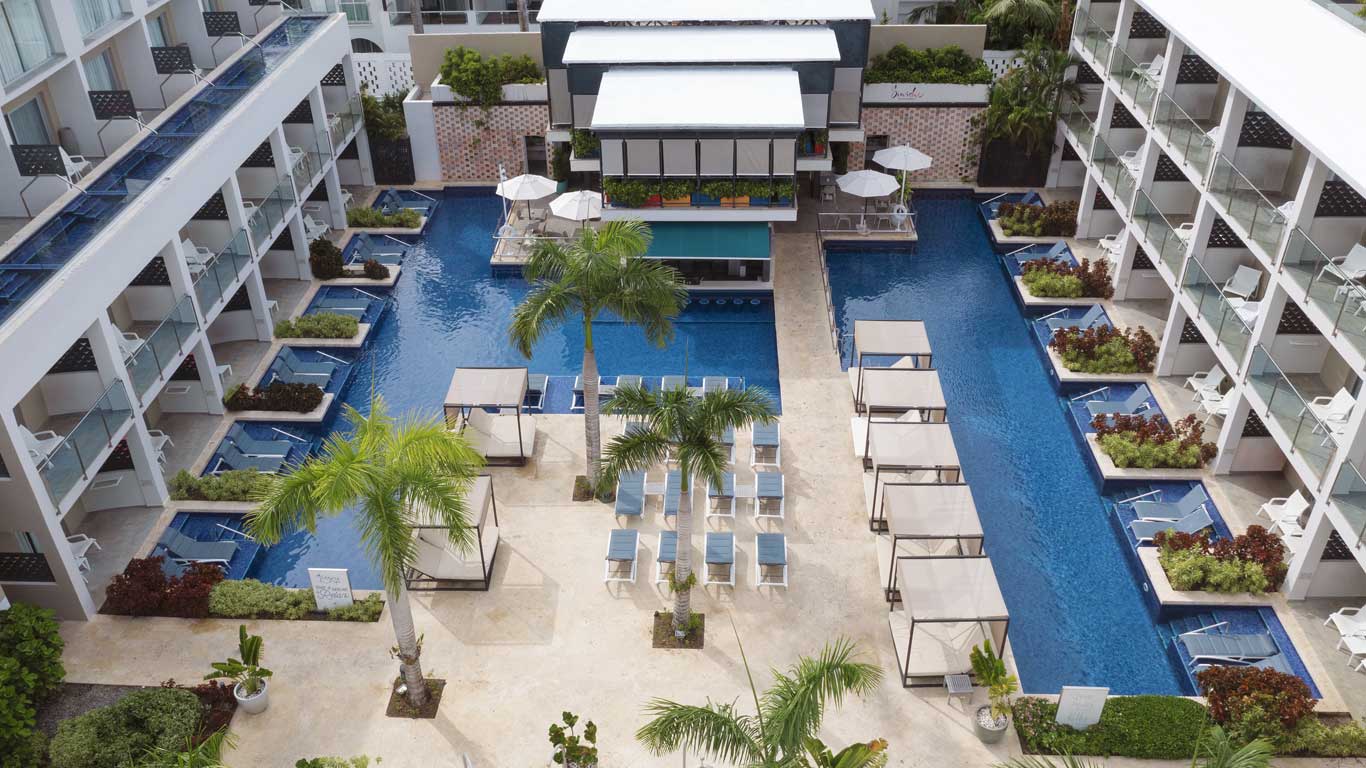 Catalonia Royal La Romana adults-only all-inclusive beachfront resort with pools and tropical palm-lined beach in La Romana.