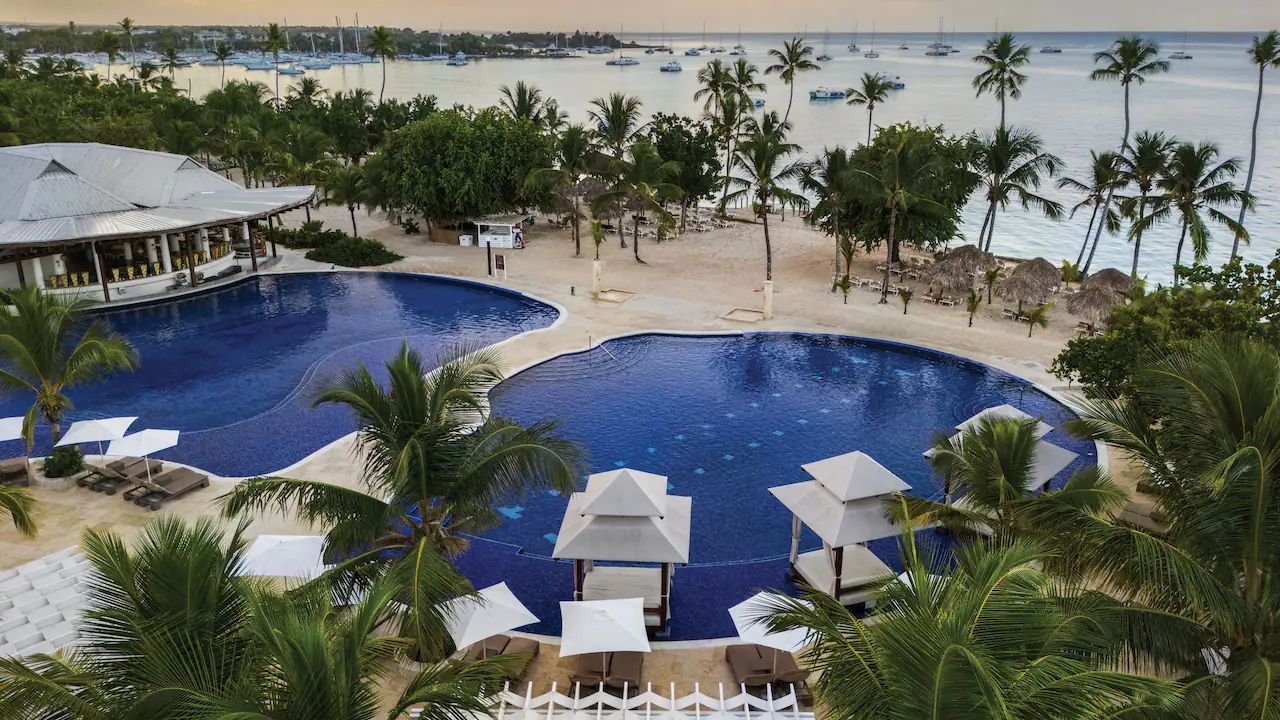 Aerial view of the infinity pool and beachfront at Secrets La Romana Resort & Spa in the Dominican Republic