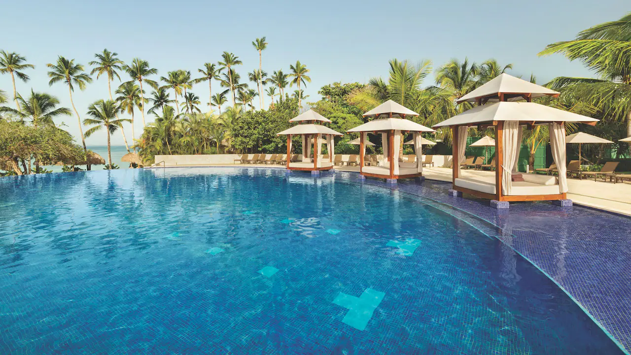 Luxury cabanas beside the infinity pool overlooking the Caribbean Sea at Secrets La Romana Resort & Spa.