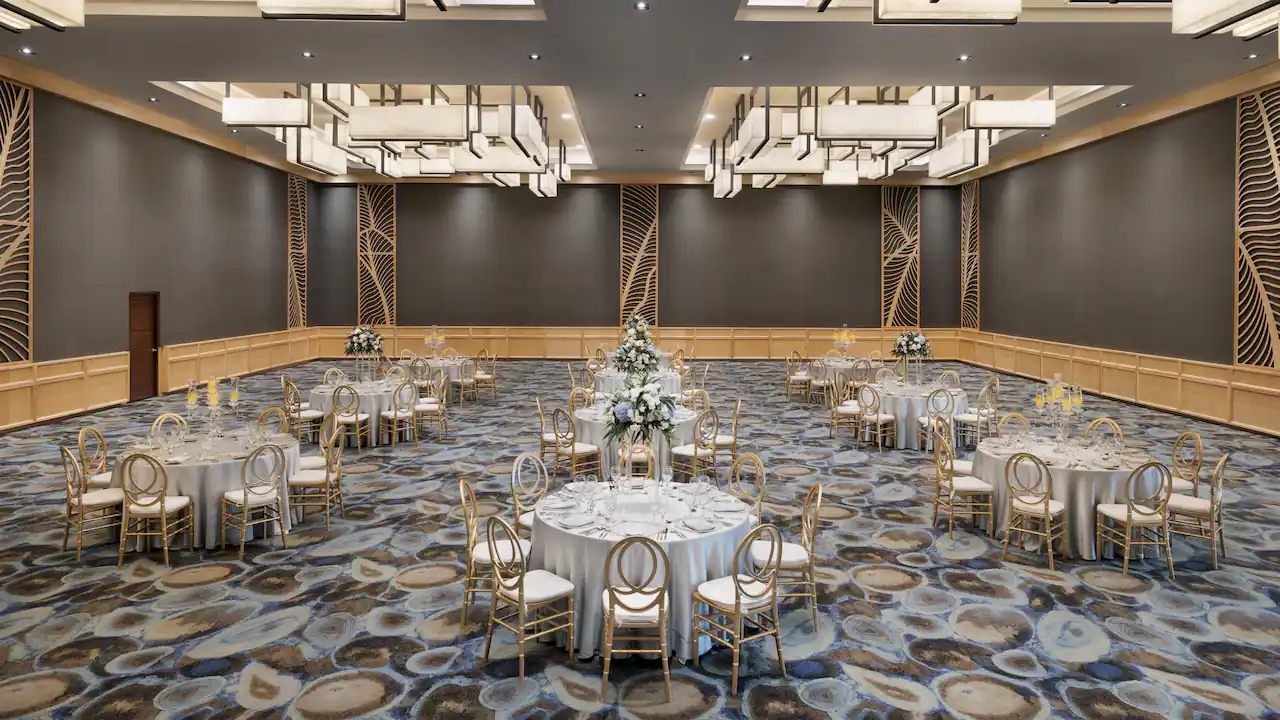 Elegant ballroom event setup with round tables at Secrets La Romana Resort & Spa.