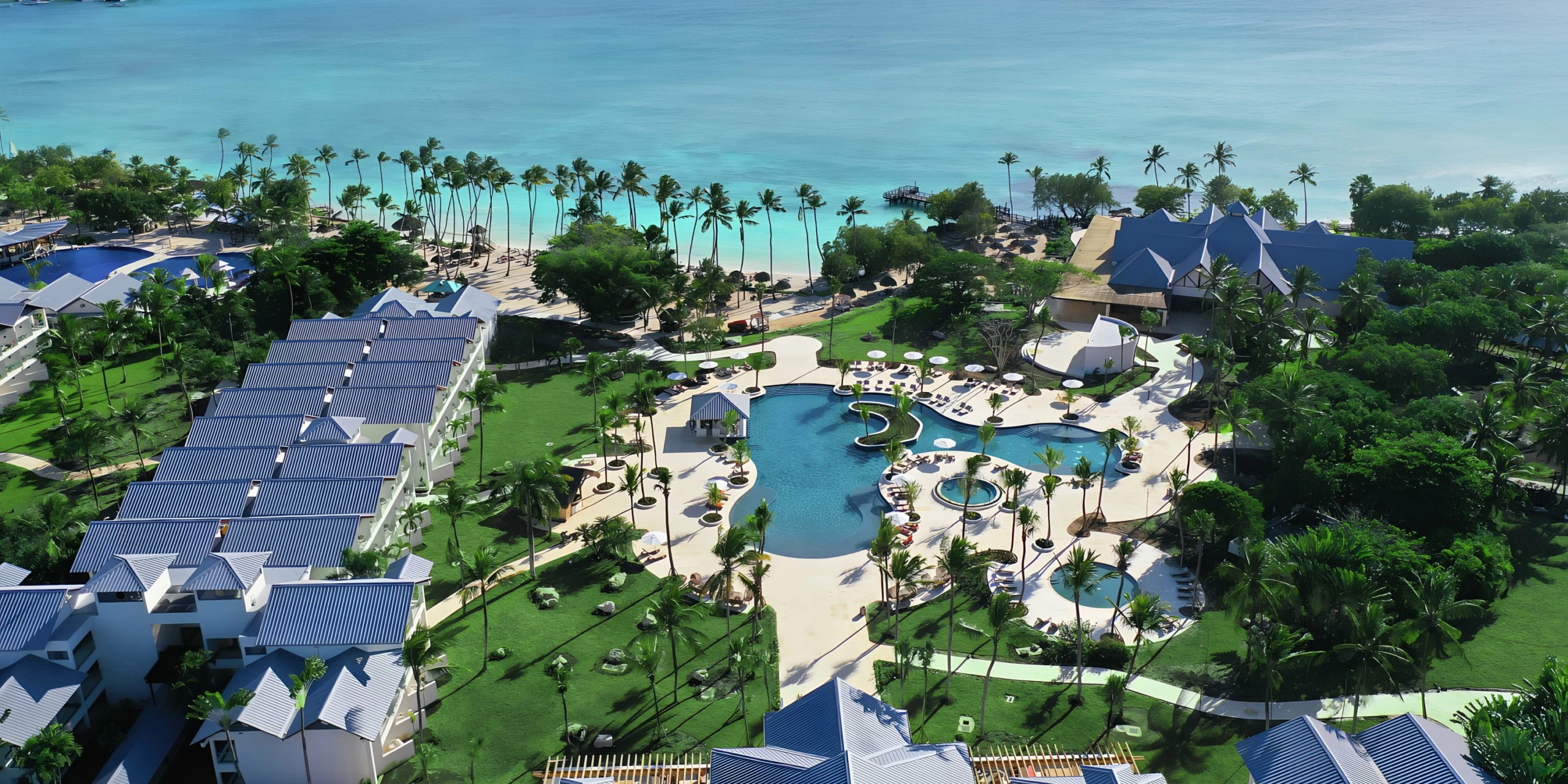 Aerial view of the main resort pool and beachfront at Secrets La Romana Resort & Spa.