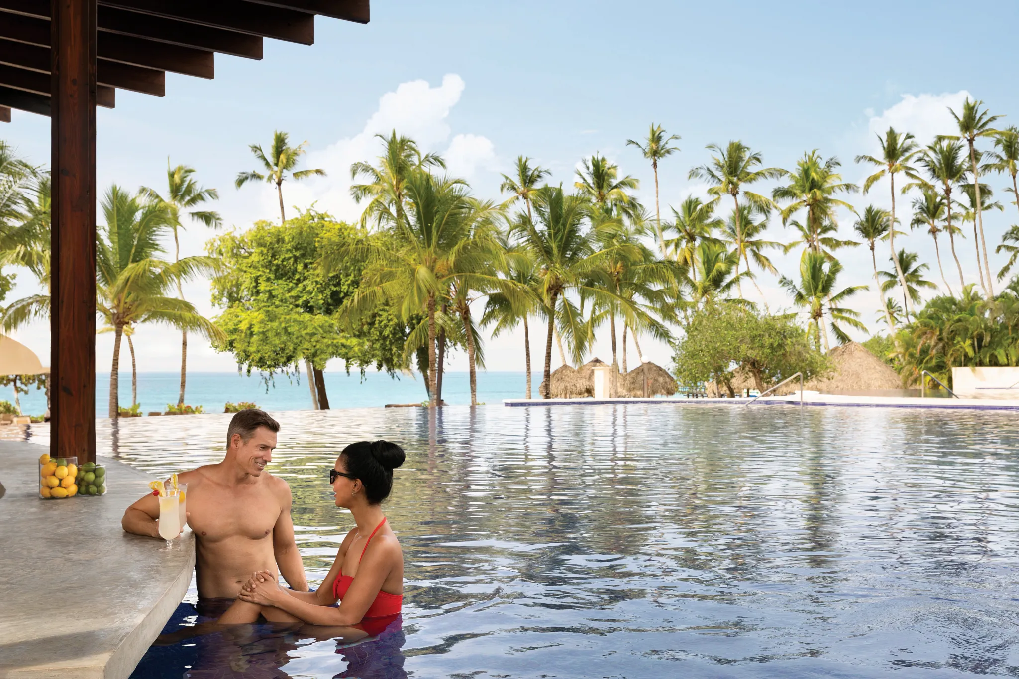 Soleil Swim-Up Bar at Secrets La Romana Resort & Spa featuring refreshing cocktails, poolside seating, and tropical resort views.
