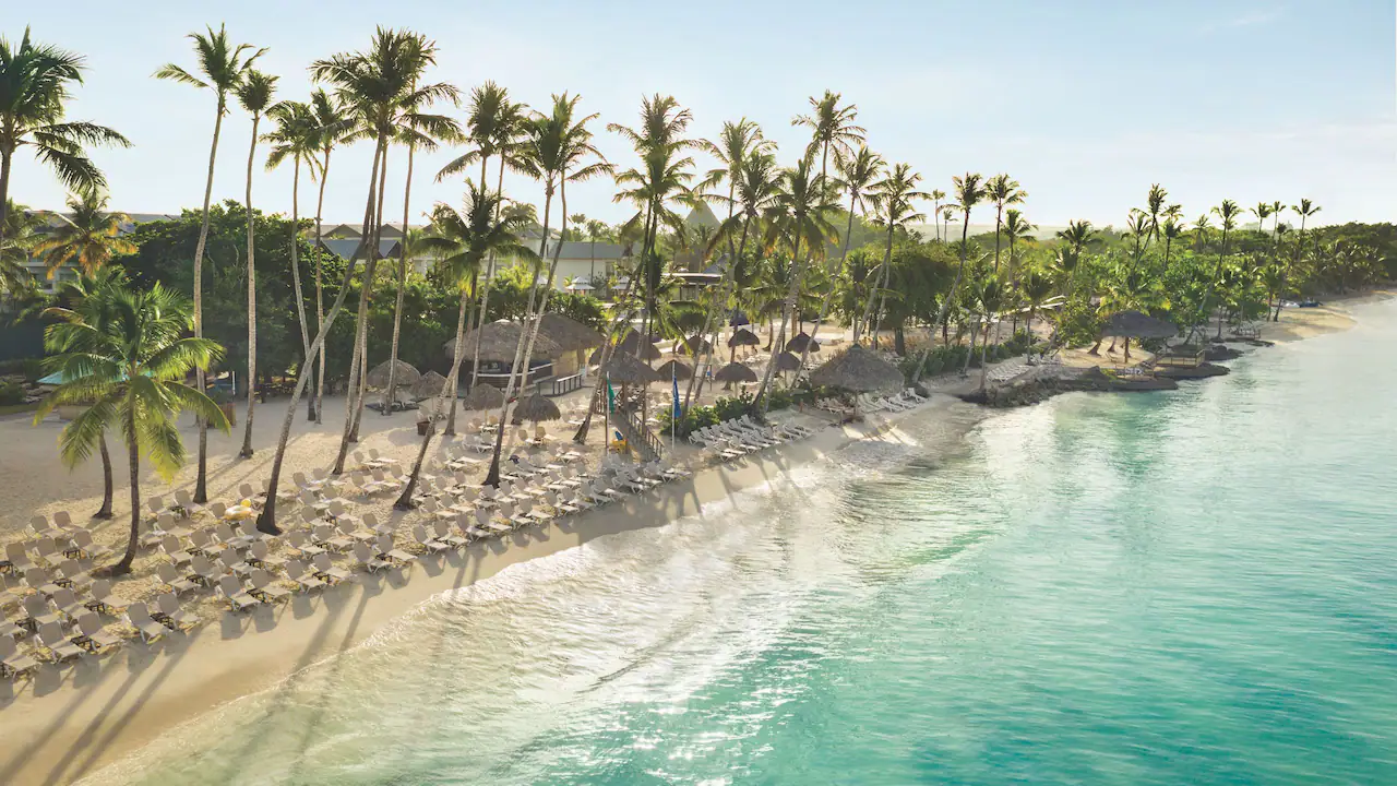 Aerial view of the tropical beachfront and turquoise waters at Secrets La Romana Resort & Spa.